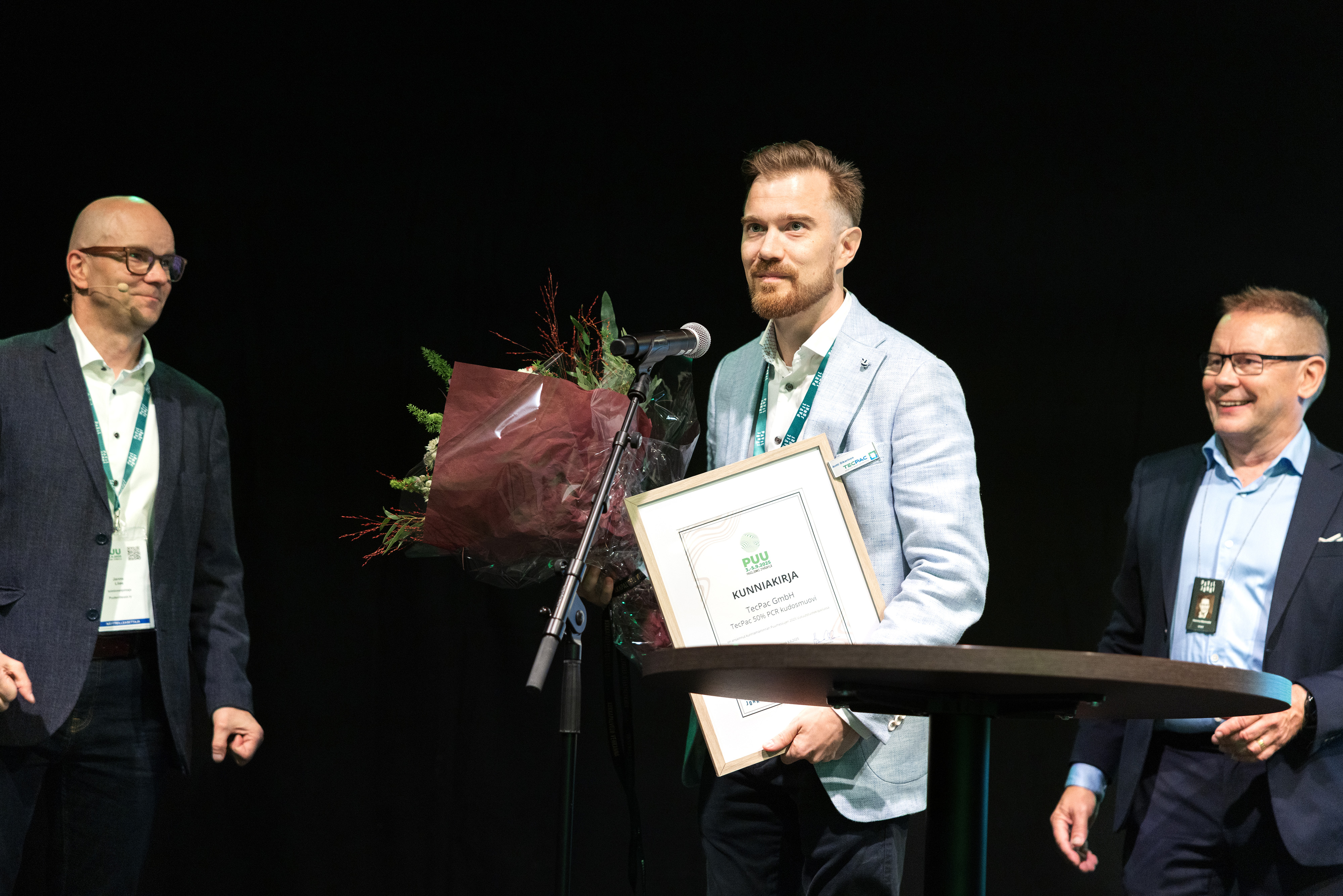 Antti Oikarinen of TecPac GmbH on stage at the biannual Wood Trade Fair in Jyväskylä, Finland, being honored for 50% PCR content.